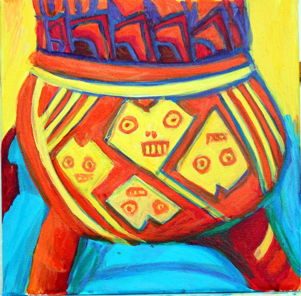 an orange and yellow clay pot with short legs and a fun geometric design suggesting faces